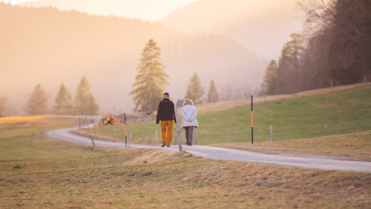 An older couple walking together outdoors